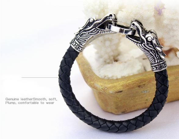 สร้อยข้อมือผู้ชาย หนังแท้ สีดำ ดีไซน์ เป็น หัวมังกร เงิน คาบห่วง 2 หัว ตัวสายสร้อยข้อมือ ทำเป็นหนังถัก สร้อยข้อมือ เสริมบารมี no 285701
